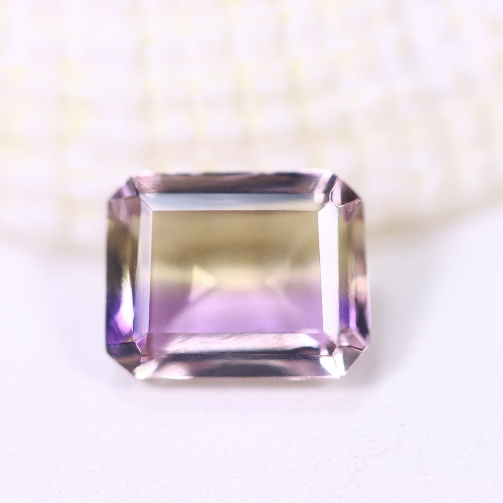 1.79Ct Ametrine - Polished Faceted - Rectangle Faceted , 1000E: Ksmith Heritage Auctioneers Subject: Natural Ametrine Origin: Bolivia Carat Weight: 1.79Ct Dimension: 8.5x6.6x3.9 mm Treatment: Unheated Shape: Rectangle Type: F