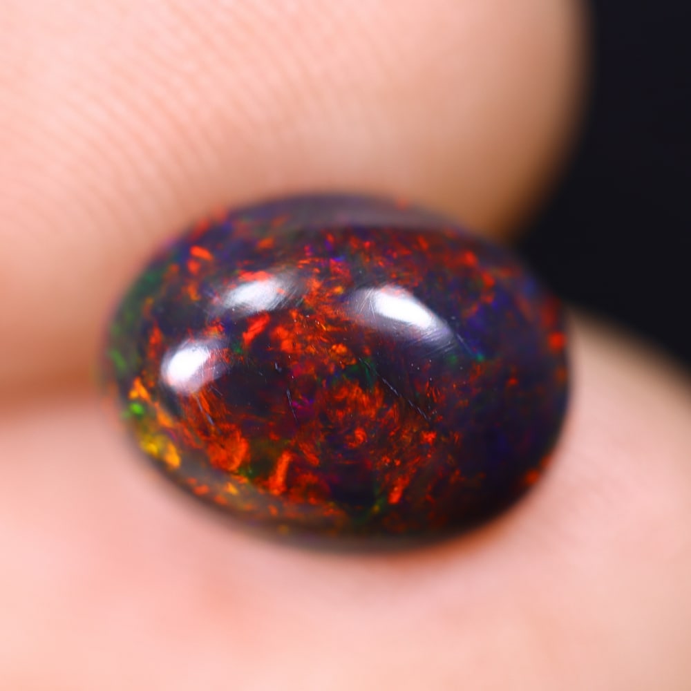 1.42Ct Welo Black Opal Polished - Ethiopian Opal , 1211E: Ksmith Heritage Auctioneers Subject: Natural Ethiopian Welo Black Opal Origin: Ethiopia Carat Weight: 1.42Ct Dimension: 9.9x7.8x3.8 mm Treatment: Smoked Type: Cabochon, Po