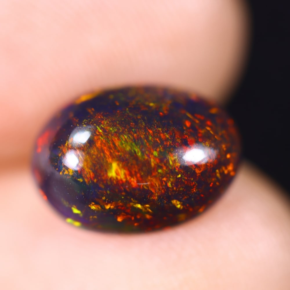 2.04Ct Welo Black Opal Polished - Ethiopian Opal , 259E: Ksmith Heritage Auctioneers Subject: Natural Ethiopian Welo Black Opal Origin: Ethiopia Carat Weight: 2.04Ct Dimension: 11.4x8.2x4.5 mm Treatment: Smoked Type: Cabochon, P