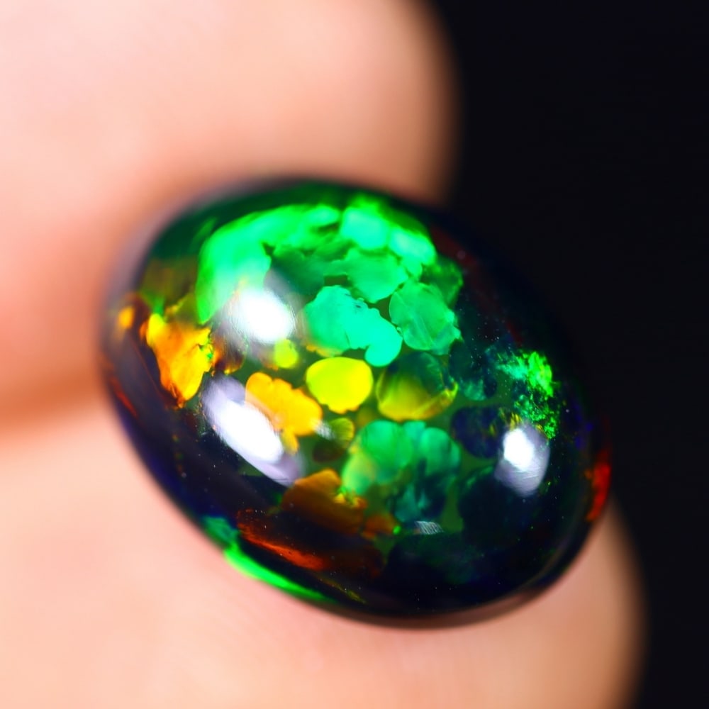 4.47Ct Welo Black Opal Polished - Ethiopian Opal - Oval Cabochon , 116E: Ksmith Heritage Auctioneers Subject: Natural Ethiopian Welo Black Opal Origin: Ethiopia Carat Weight: 4.47Ct Dimension: 14.5 x 10.6 x 5.7 mm Treatment: Smoked Shape: Oval<