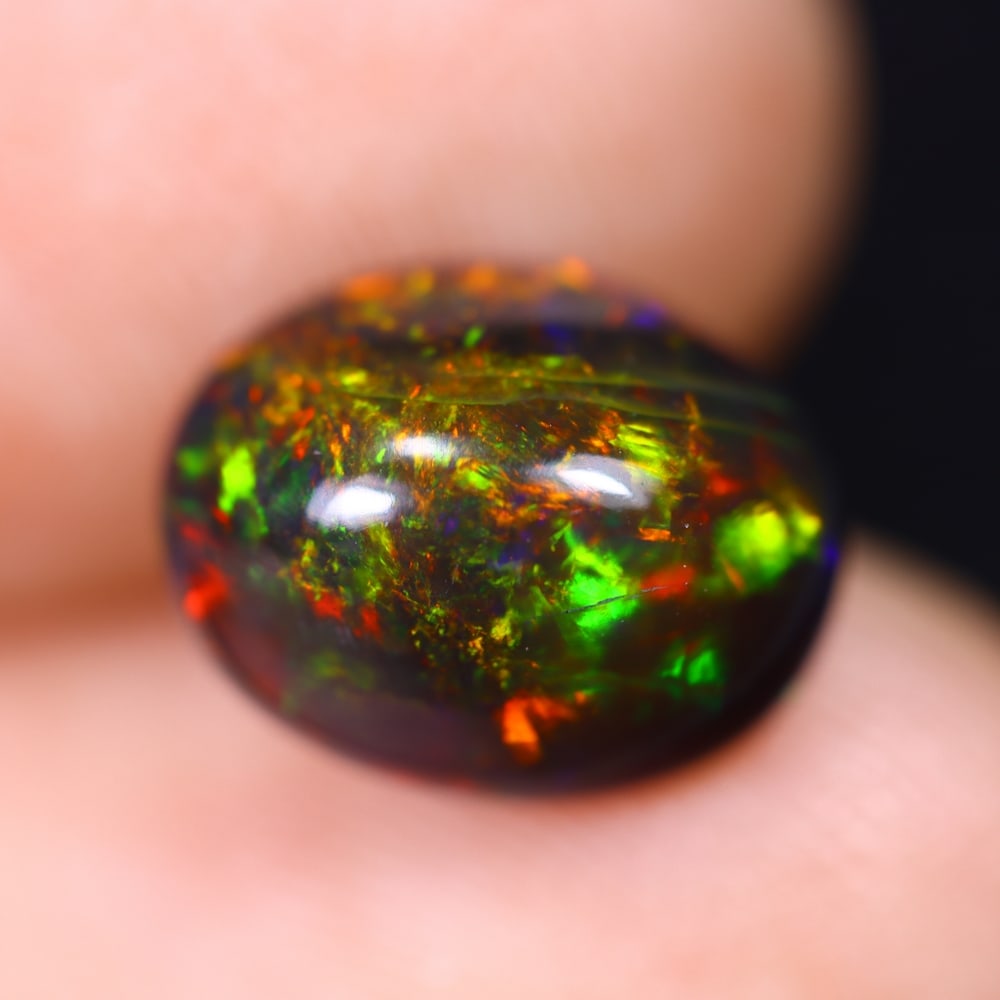 1.68Ct Welo Black Opal Polished - Ethiopian Opal , 1169E: Ksmith Heritage Auctioneers Subject: Natural Ethiopian Welo Black Opal Origin: Ethiopia Carat Weight: 1.68Ct Dimension: 10.1x7.9x4.7 mm Treatment: Smoked Type: Cabochon, P