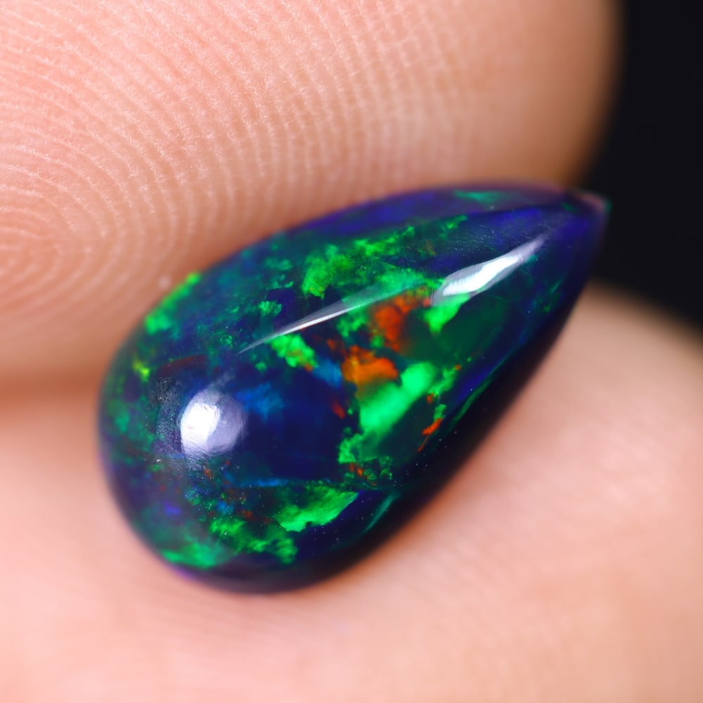 1.38Ct Welo Black Opal Polished - Ethiopian Opal , 958E: Ksmith Heritage Auctioneers Subject: Natural Ethiopian Welo Black Opal Origin: Ethiopia Carat Weight: 1.38Ct Dimension: 12.2x7x3.5 mm Treatment: Smoked Type: Cabochon, Pol