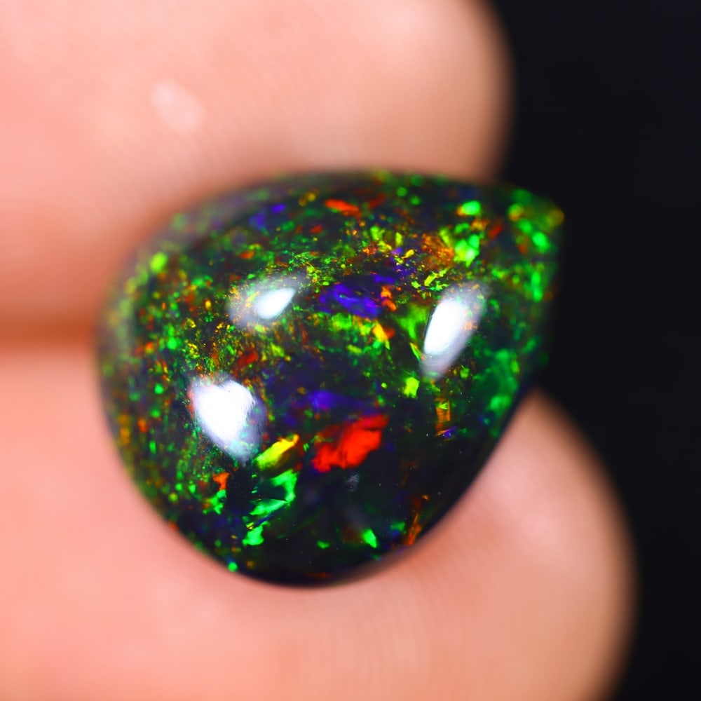 5.16Ct Welo Black Opal Polished - Ethiopian Opal - Pear Cabochon , 36E: Ksmith Heritage Auctioneers Subject: Natural Ethiopian Welo Black Opal Origin: Ethiopia Carat Weight: 5.16Ct Dimension: 14.3x12.3x6.6 mm Treatment: Smoked Shape: Pear <