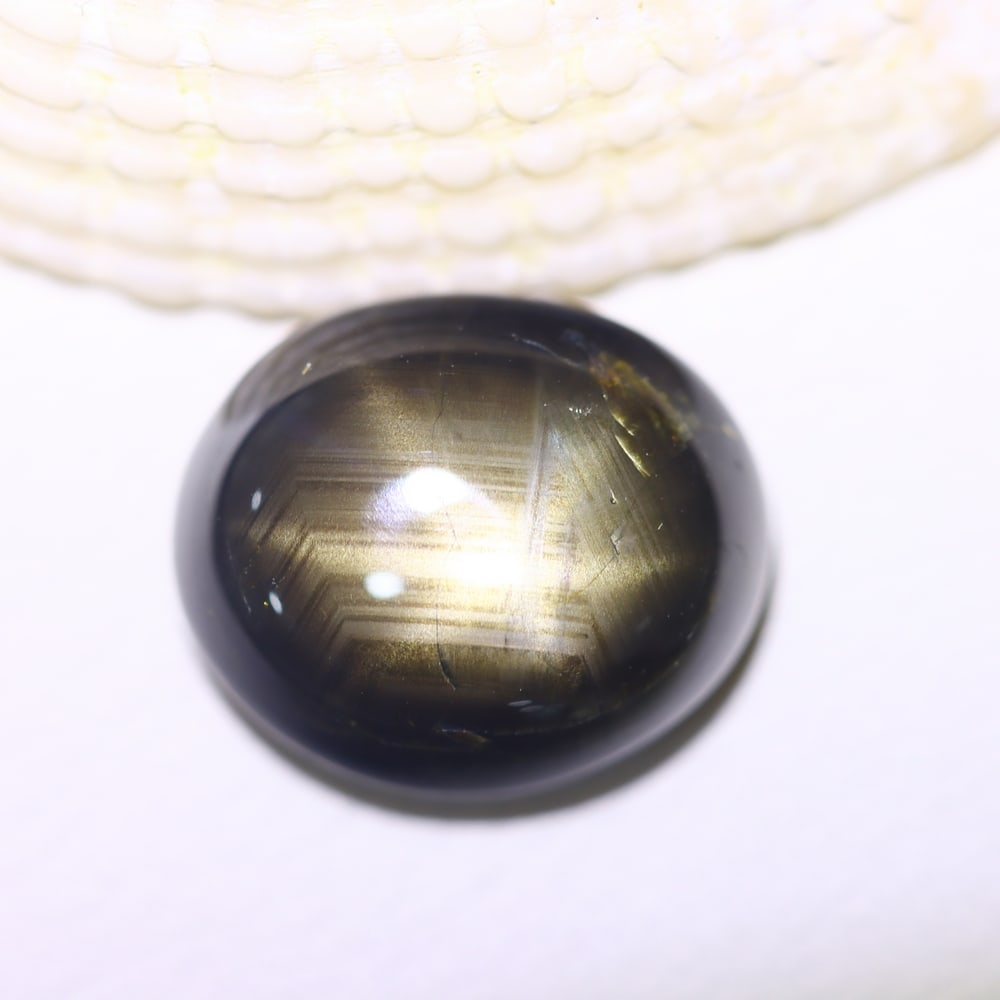 7.90cts 6 Rays Black Star Sapphire , 745E: Ksmith Heritage Auctioneers Subject: Natural 6 Rays Star Sapphire Origin: Myanmar Carat Weight: 7.90cts Dimension: 11.5x9.7x5.7 mm Treatment: Diffusion Type: Cabochon, Pol