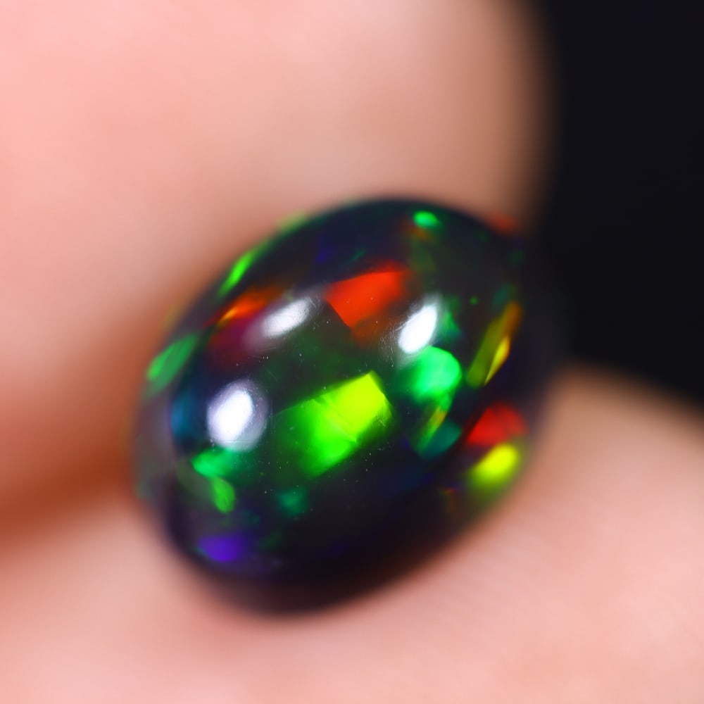 2.21Ct Welo Black Opal Polished - Ethiopian Opal , 907E: Ksmith Heritage Auctioneers Subject: Natural Ethiopian Welo Black Opal Origin: Ethiopia Carat Weight: 2.21Ct Dimension: 10.3x7.6x5.5 mm Treatment: Smoked Type: Cabochon, P