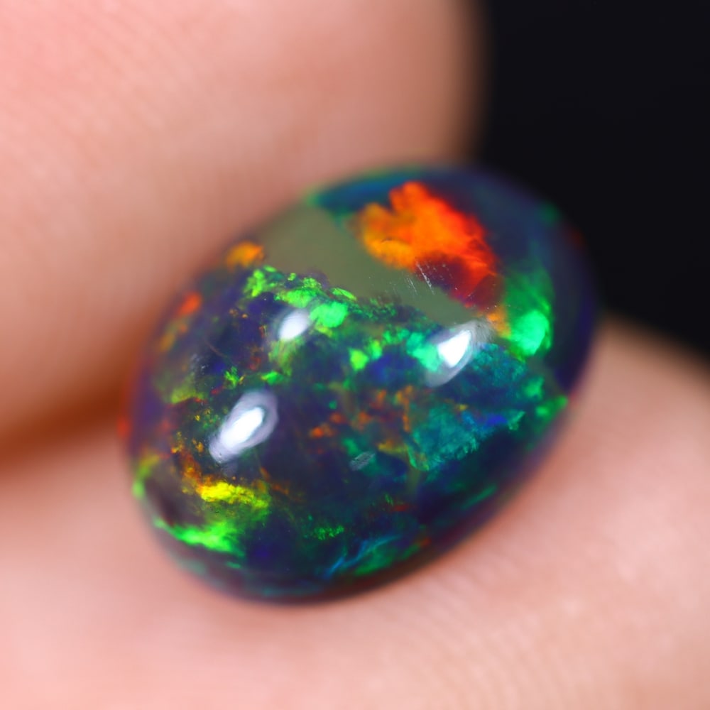 1.82Ct Welo Black Opal Polished - Ethiopian Opal , 54E: Ksmith Heritage Auctioneers Subject: Natural Ethiopian Welo Black Opal Origin: Ethiopia Carat Weight: 1.82Ct Dimension: 10.8x8.1x4.3 mm Treatment: Smoked Type: Cabochon, P