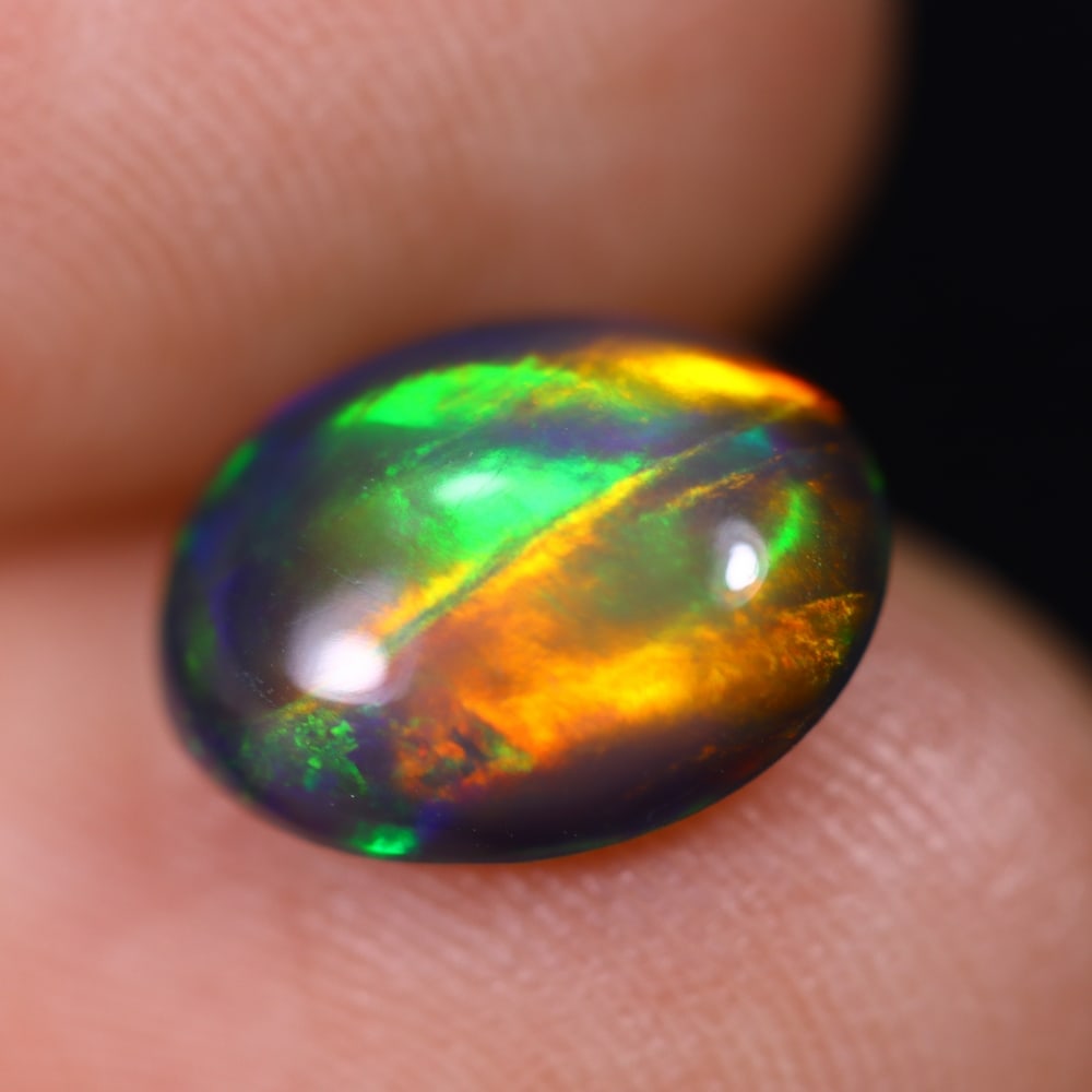 1.54Ct Welo Black Opal Polished - Ethiopian Opal , 774E: Ksmith Heritage Auctioneers Subject: Natural Ethiopian Welo Black Opal Origin: Ethiopia Carat Weight: 1.54Ct Dimension: 10.1x8x3.8 mm Treatment: Smoked Type: Cabochon, Pol