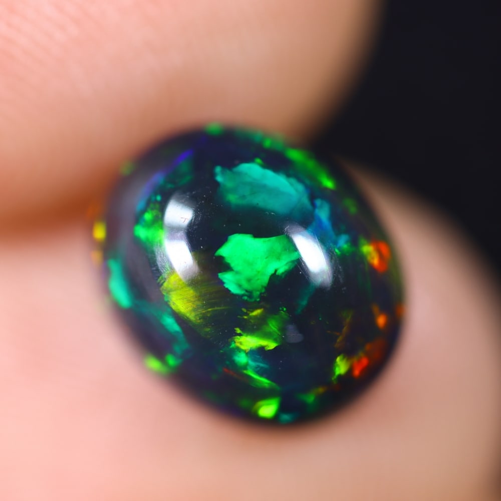 2.24Ct Welo Black Opal Polished - Ethiopian Opal , 337E: Ksmith Heritage Auctioneers Subject: Natural Ethiopian Welo Black Opal Origin: Ethiopia Carat Weight: 2.24Ct Dimension: 10.1x8.2x5.2 mm Treatment: Smoked Type: Cabochon, P