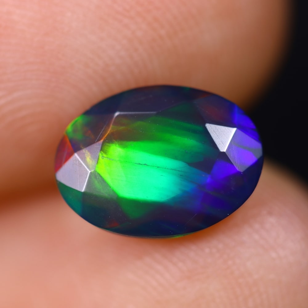 1.43Ct Welo Black Faceted Opal Polished - Ethiopian Opal , 281E: Ksmith Heritage Auctioneers Subject: Natural Ethiopian Welo Black Opal Origin: Ethiopia Carat Weight: 1.43Ct Dimension: 10.2x7.5x4.1 mm Treatment: Smoked Type: Faceted, Po