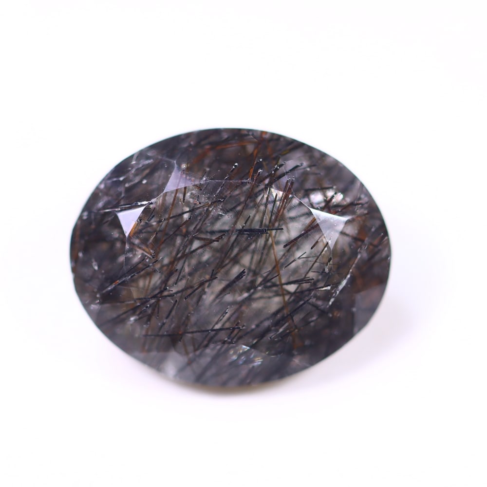 10.12ct Black Rutiled Quartz - Polished Faceted , 700E: Ksmith Heritage Auctioneers Subject: Natural Black Rutiled Quartz Carat Weight: 10.12ct Dimension: 15.9 x 12.8 x 8.3 mm