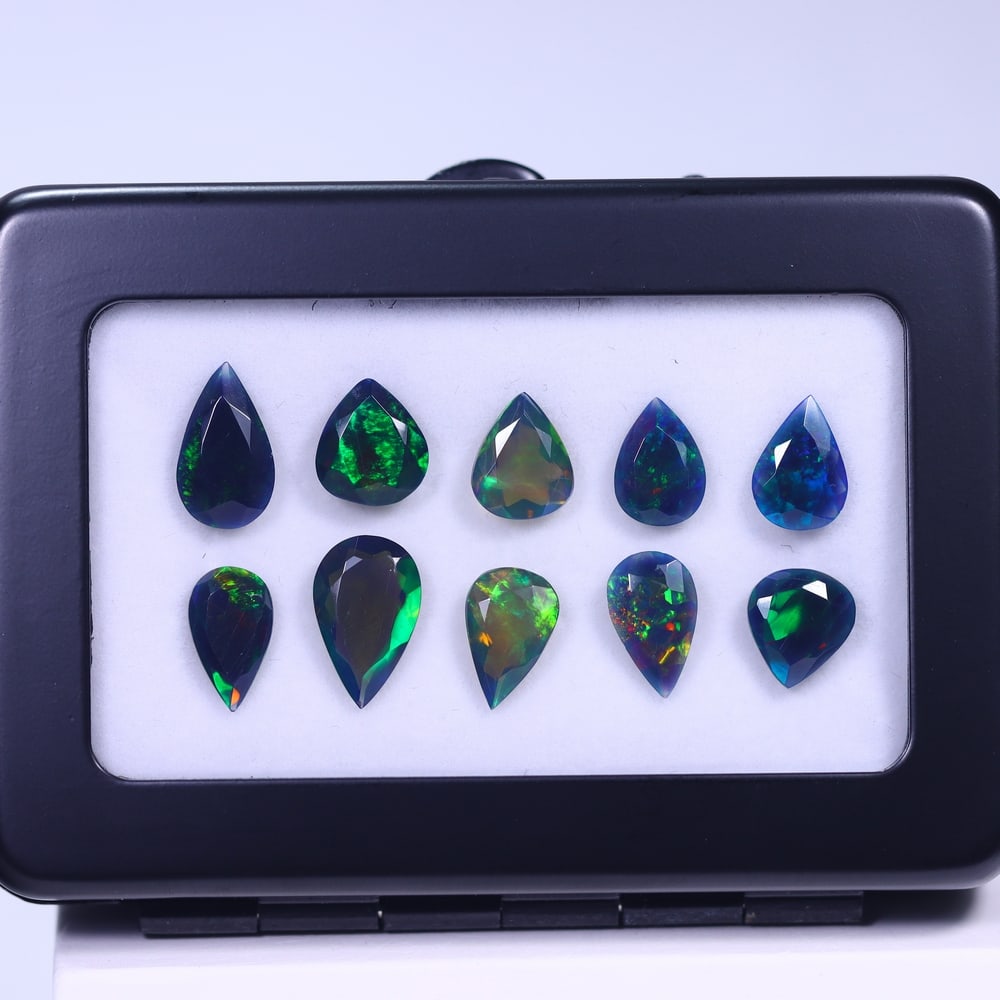 *12.38Ct 10pcs Faceted Smoked Welo Opal Set - Ethiopian Opal , 400E: Ksmith Heritage Auctioneers Subject: Natural Ethiopian Black Welo Opal Origin: Ethiopia Carat Weight: 12.38Ct Dimension: 11x7x4 mm Treatment: Heated Type: Faceted, Polishe