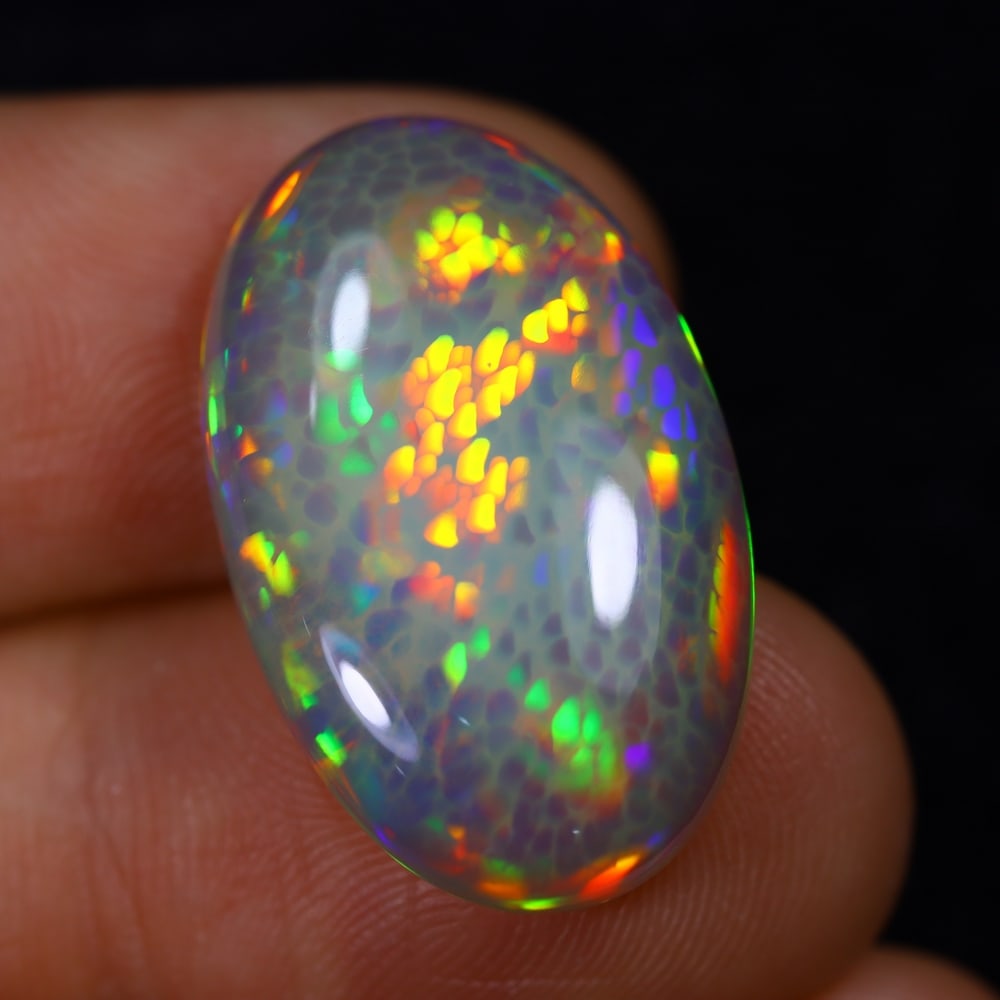 *12.25Ct Dark Base Welo Opal Polished - Ethiopian Opal , 637E: Ksmith Heritage Auctioneers Subject: Natural Ethiopian Welo Opal Origin: Ethiopia Carat Weight: 12.25Ct Dimension: 23.6x14.5x6.3 mm Treatment: Natural Untreated Type: Cabo