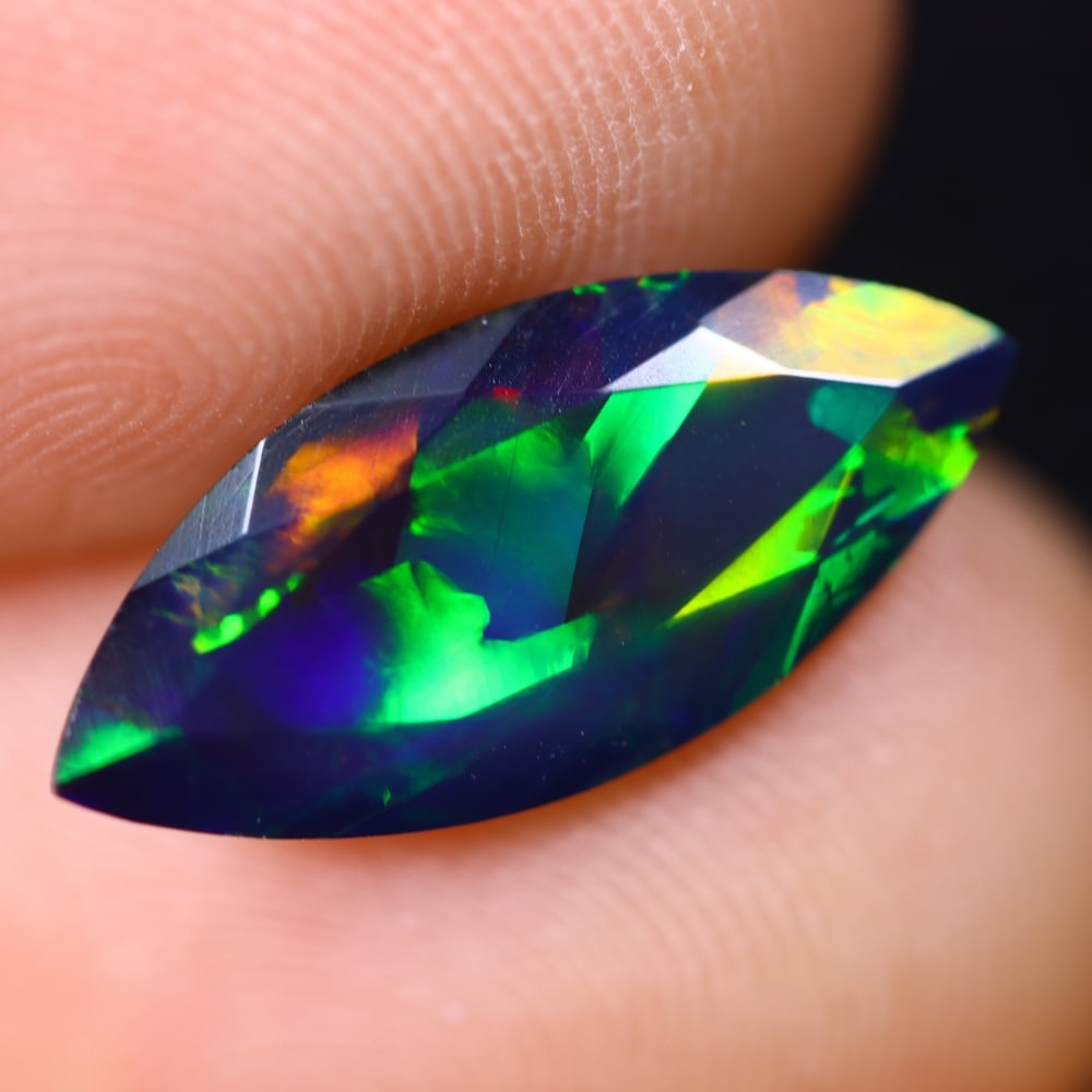 1.68Ct Welo Black Opal Faceted Polished - Ethiopian Opal , 599E: Ksmith Heritage Auctioneers Subject: Natural Ethiopian Welo Black Opal Origin: Ethiopia Carat Weight: 1.68Ct Dimension: 16.2x7.2x3.7 mm Treatment: Smoked Type: Faceted, Po