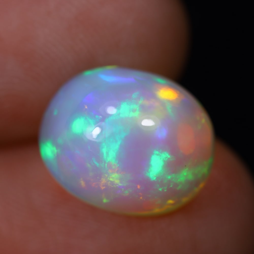 4.66Ct Welo Opal Polished - Ethiopian Opal, 975B: Ksmith Heritage Auctioneers Subject: Natural Ethiopian Welo Opal Origin: Ethiopia Carat Weight: 4.66Ct Dimension: 12.4x10.2x7.5 mm Treatment: Natural Untreated Type: Cabochon,