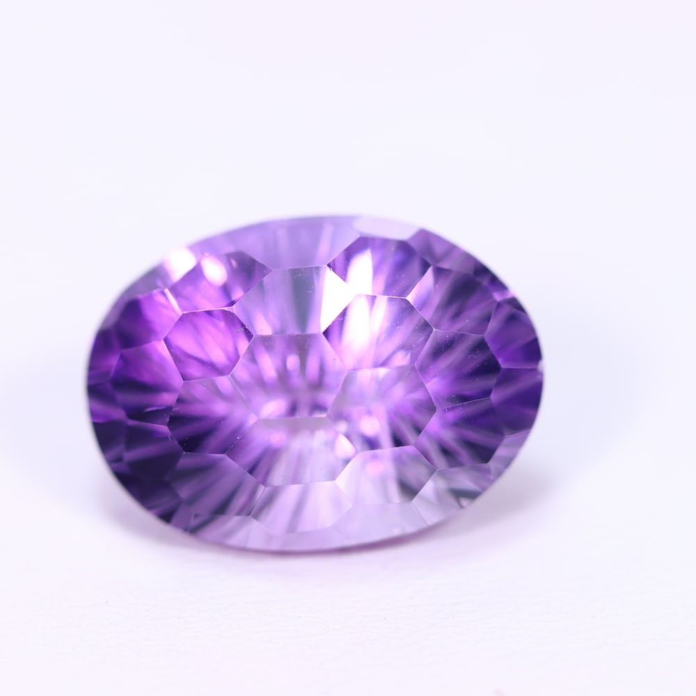 12.74Ct Purple Amethyst - Polished Faceted , 500E: Ksmith Heritage Auctioneers Subject: Natural Amethyst Origin: Brazil Carat Weight: 12.74Ct Dimension: 17.6x12.8x10.6 mm Treatment: Untreated Type: Faceted, Polished