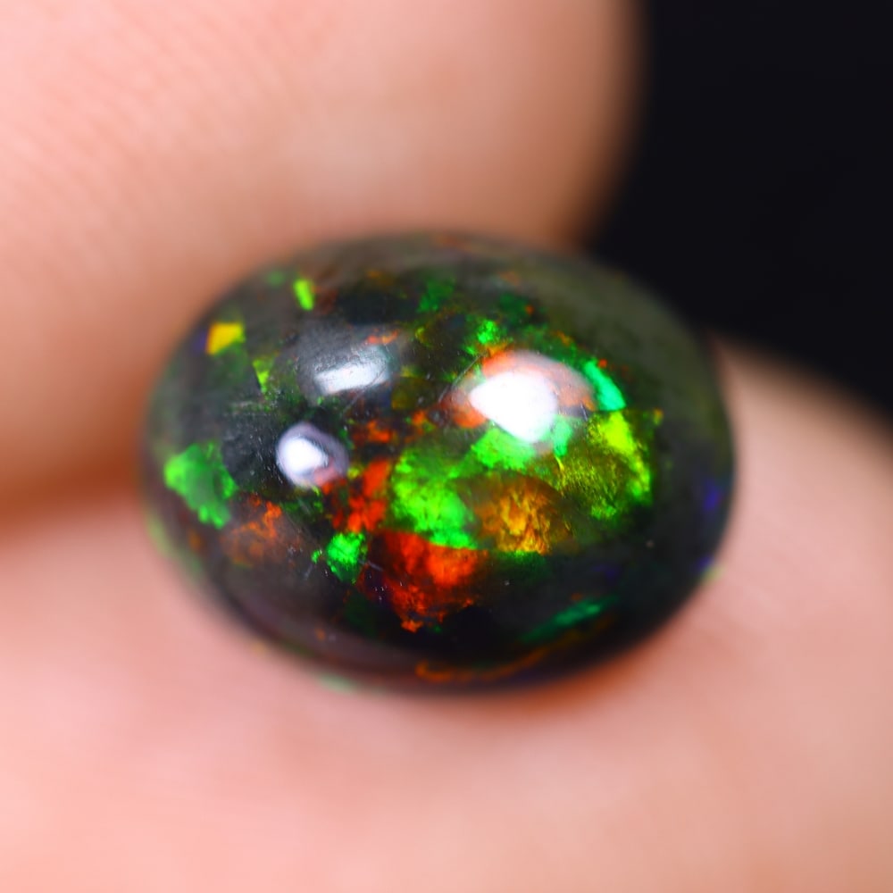 2.01Ct Welo Black Opal Polished - Ethiopian Opal , 391E: Ksmith Heritage Auctioneers Subject: Natural Ethiopian Welo Black Opal Origin: Ethiopia Carat Weight: 2.01Ct Dimension: 9.9x7.9x5.1 mm Treatment: Smoked Type: Cabochon, Po