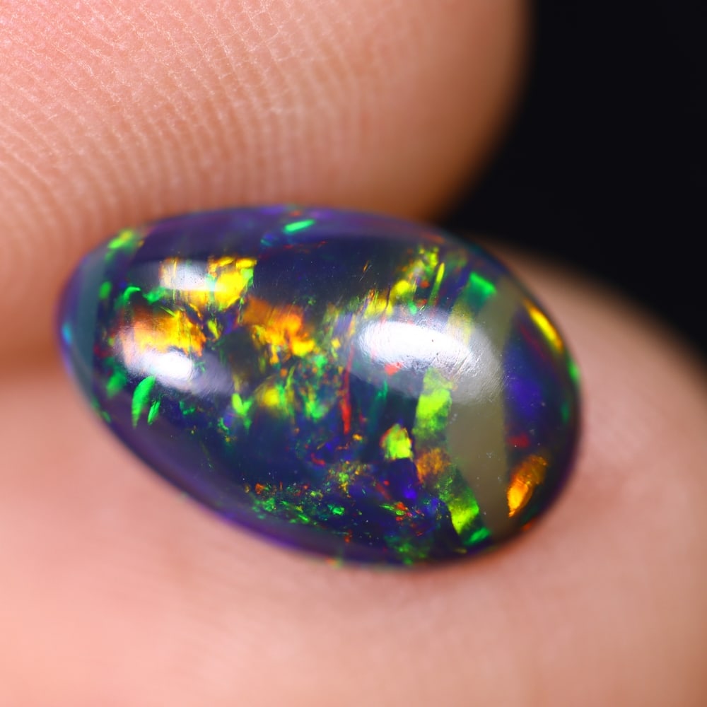 1.27Ct Welo Black Opal Polished - Ethiopian Opal , 501E: Ksmith Heritage Auctioneers Subject: Natural Ethiopian Welo Black Opal Origin: Ethiopia Carat Weight: 1.27Ct Dimension: 11.2x7.3x3.4 mm Treatment: Smoked Type: Cabochon, P