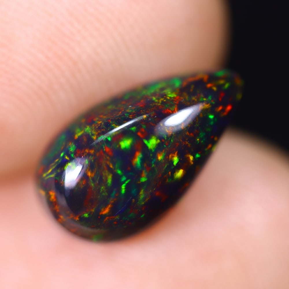 1.79Ct Welo Black Opal Polished - Ethiopian Opal , 371E: Ksmith Heritage Auctioneers Subject: Natural Ethiopian Welo Black Opal Origin: Ethiopia Carat Weight: 1.79Ct Dimension: 12.3x7x4.4 mm Treatment: Smoked Type: Cabochon, Pol