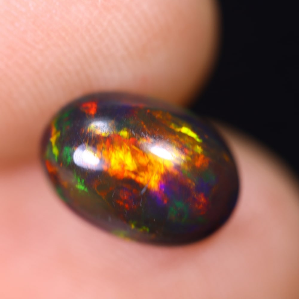 1.58Ct Welo Black Opal Polished - Ethiopian Opal , 329E: Ksmith Heritage Auctioneers Subject: Natural Ethiopian Welo Black Opal Origin: Ethiopia Carat Weight: 1.58Ct Dimension: 10.1x7.1x4.3 mm Treatment: Smoked Type: Cabochon, P