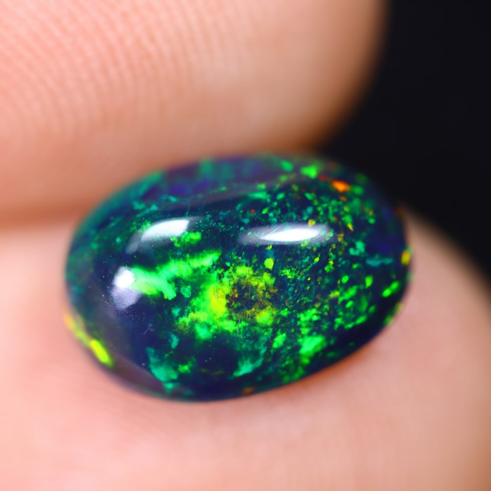 *1.71Ct Welo Black Opal Polished - Ethiopian Opal , 623E: Ksmith Heritage Auctioneers Subject: Natural Ethiopian Welo Black Opal Origin: Ethiopia Carat Weight: 1.71Ct Dimension: 10.6x7.7x4.5 mm Treatment: Smoked Type: Cabochon, P