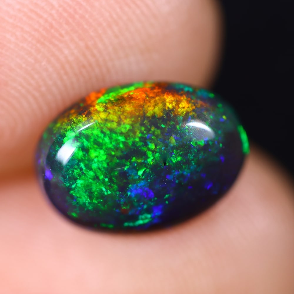 1.91Ct Welo Black Opal Polished - Ethiopian Opal , 250E: Ksmith Heritage Auctioneers Subject: Natural Ethiopian Welo Black Opal Origin: Ethiopia Carat Weight: 1.91Ct Dimension: 11.3x8.2x4.1 mm Treatment: Smoked Type: Cabochon, P