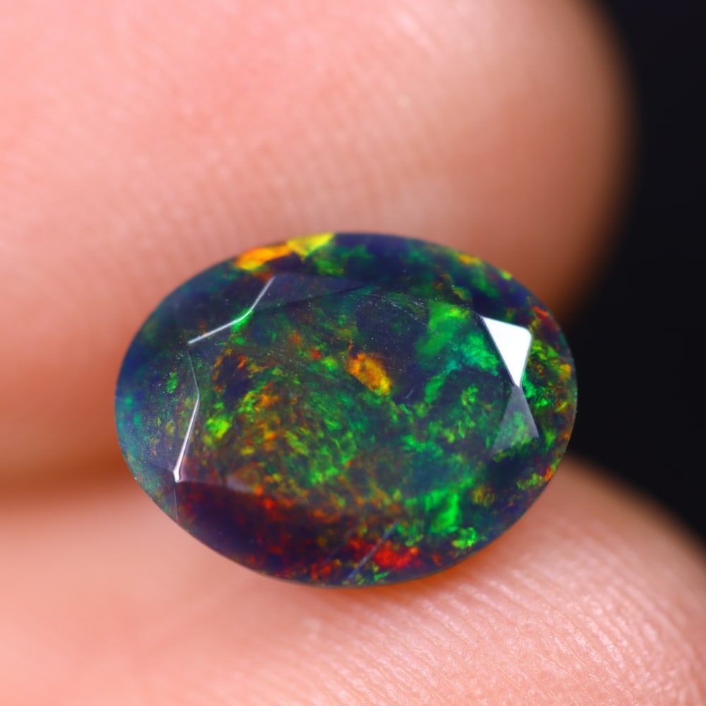 1.22Ct Welo Black Faceted Opal Polished - Ethiopian Opal , 257E: Ksmith Heritage Auctioneers Subject: Natural Ethiopian Welo Black Opal Origin: Ethiopia Carat Weight: 1.22Ct Dimension: 9.5x7.4x4.2 mm Treatment: Smoked Type: Faceted, Pol