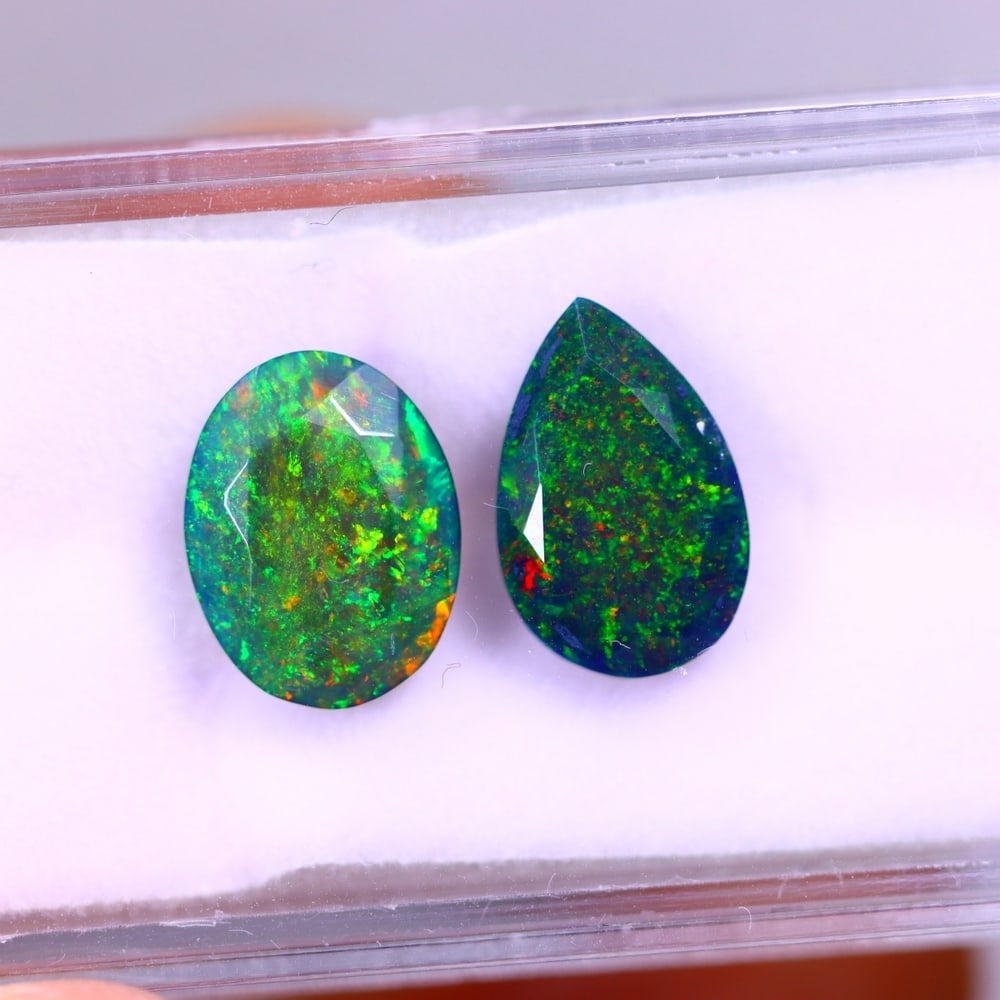 3.74Ct Group of 2 Welo Black Opal Polished - Ethiopian Opal - Faceted Set , 157E: Ksmith Heritage Auctioneers Subject: Natural Ethiopian Welo Black Opal Origin: Ethiopia Carat Weight: 3.74Ct Dimension: 10.4 x 8 x 5.8 mm Treatment: Smoked Shape: Pear, Ov