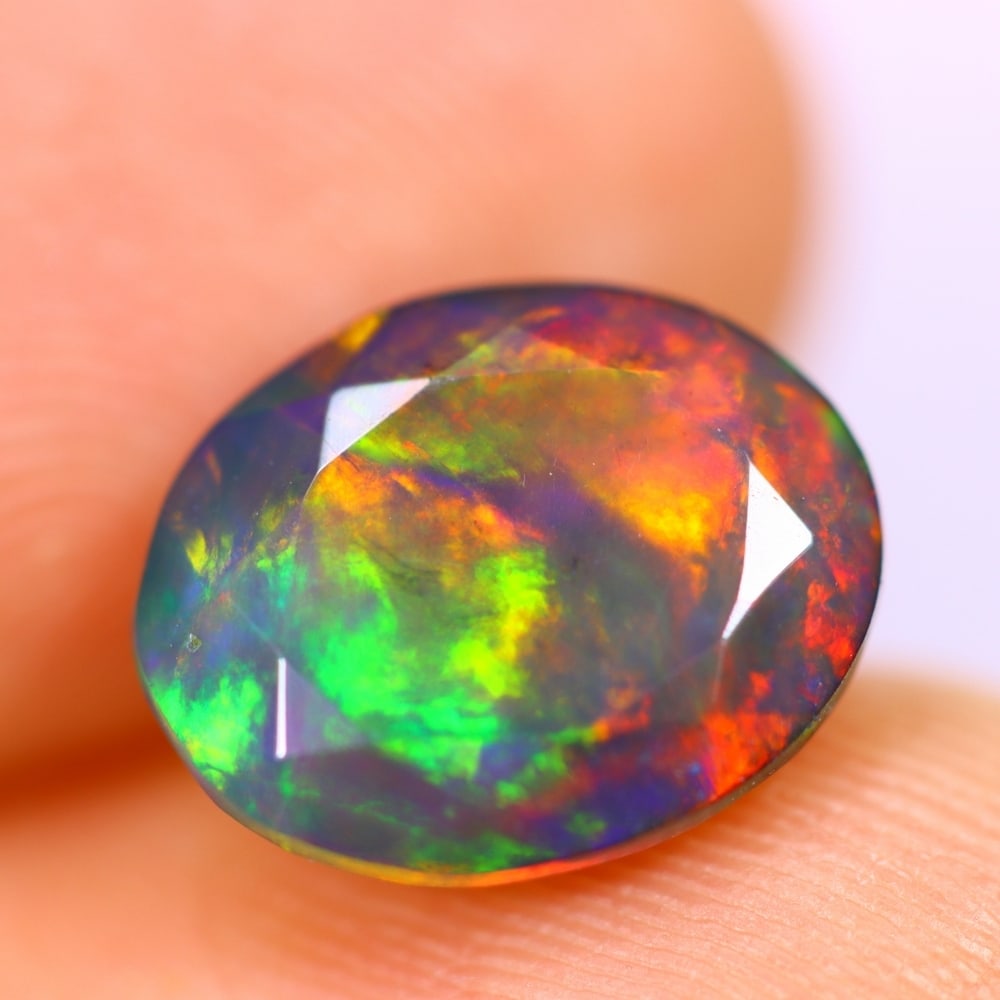 2.04Ct Welo Black Opal Polished - Ethiopian Opal - Oval Faceted , 119E: Ksmith Heritage Auctioneers Subject: Natural Ethiopian Welo Black Opal Origin: Ethiopia Carat Weight: 2.04Ct Dimension: 10.9 x 8.7 x 4.7 mm Treatment: Smoked Shape: Oval