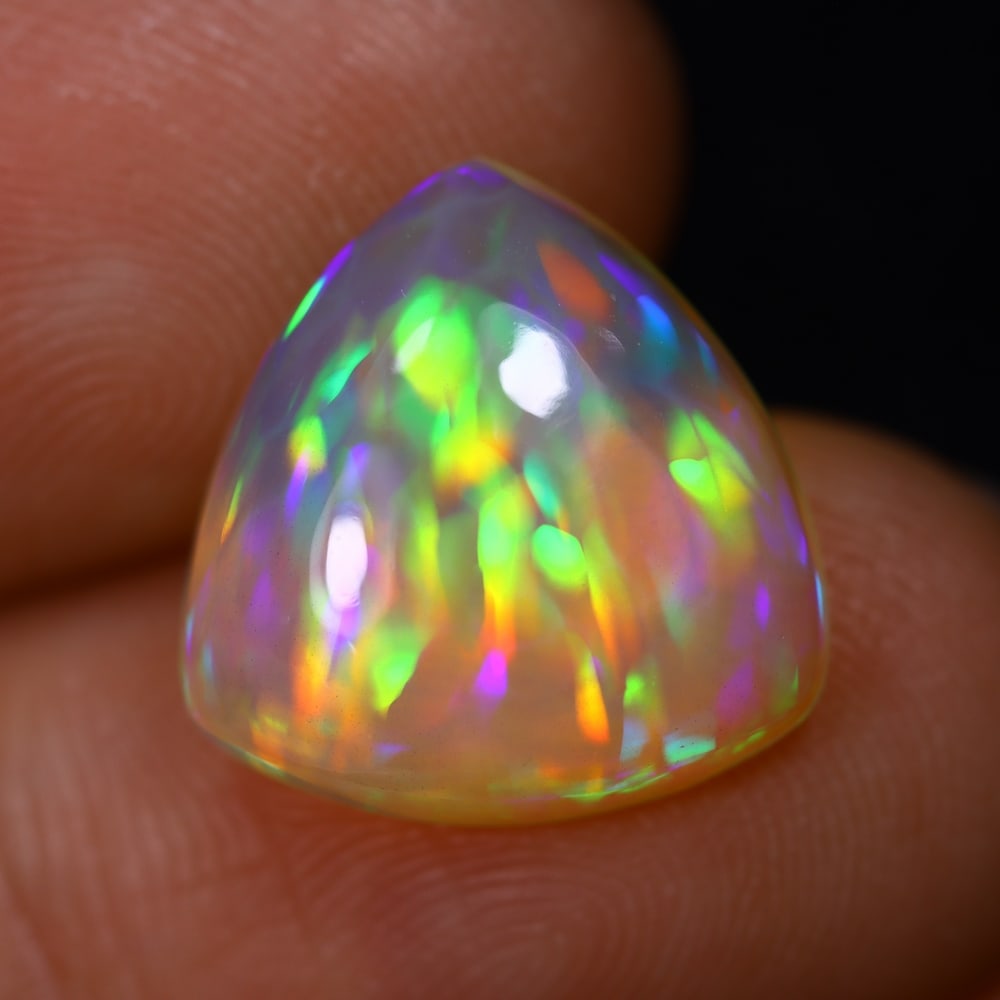 4.86Ct Welo Opal Polished - Ethiopian Opal - Triangle Cabochon, 668B: Ksmith Heritage Auctioneers Subject: Natural Ethiopian Welo Opal Origin: Ethiopia Carat Weight: 4.86Ct Dimension: 13.9x13.6x5.2 mm Treatment: Natural Untreated Shape: Triangle