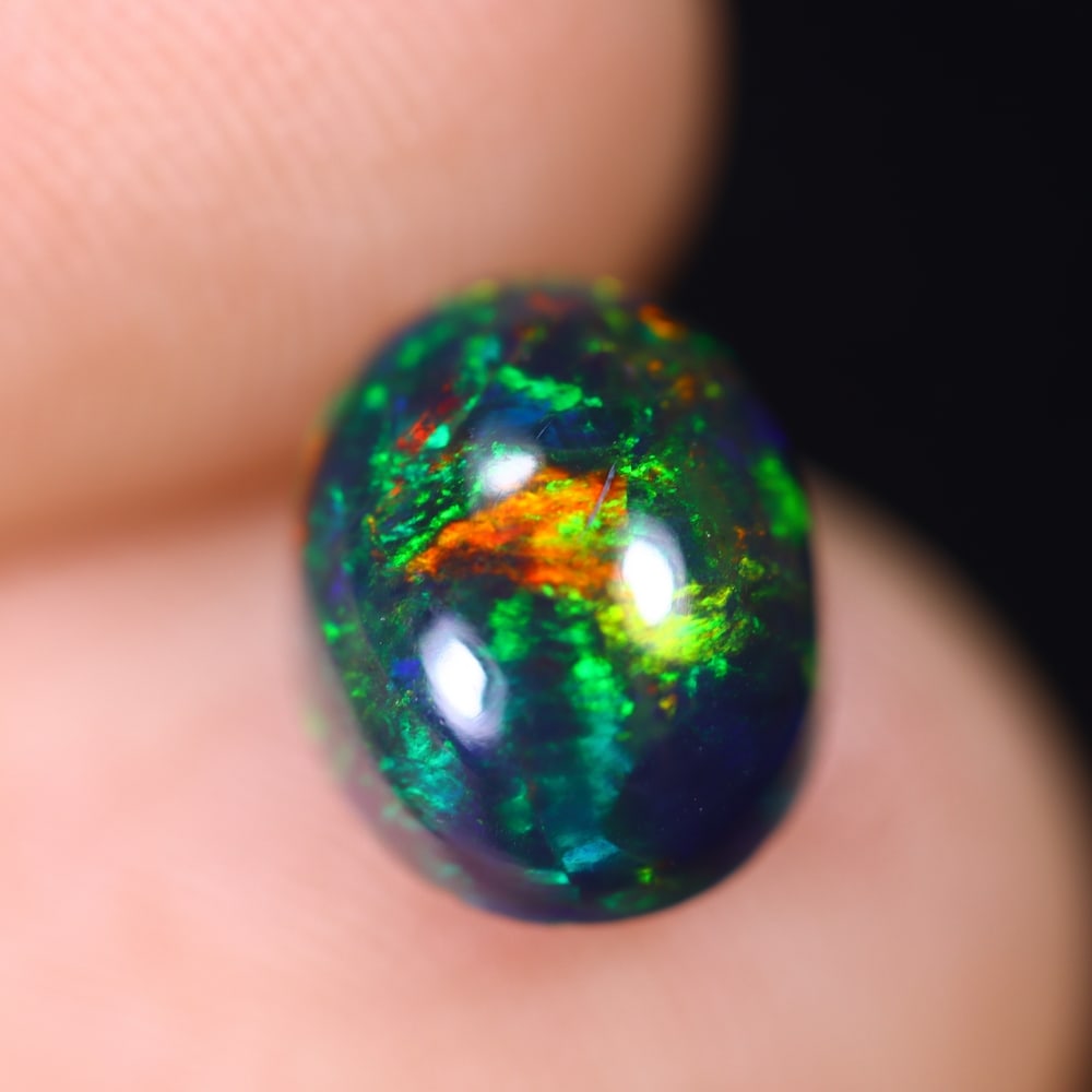 1.61Ct Welo Black Opal Polished - Ethiopian Opal , 665E: Ksmith Heritage Auctioneers Subject: Natural Ethiopian Welo Black Opal Origin: Ethiopia Carat Weight: 1.61Ct Dimension: 8.8x7x5 mm Treatment: Smoked Type: Cabochon, Polish