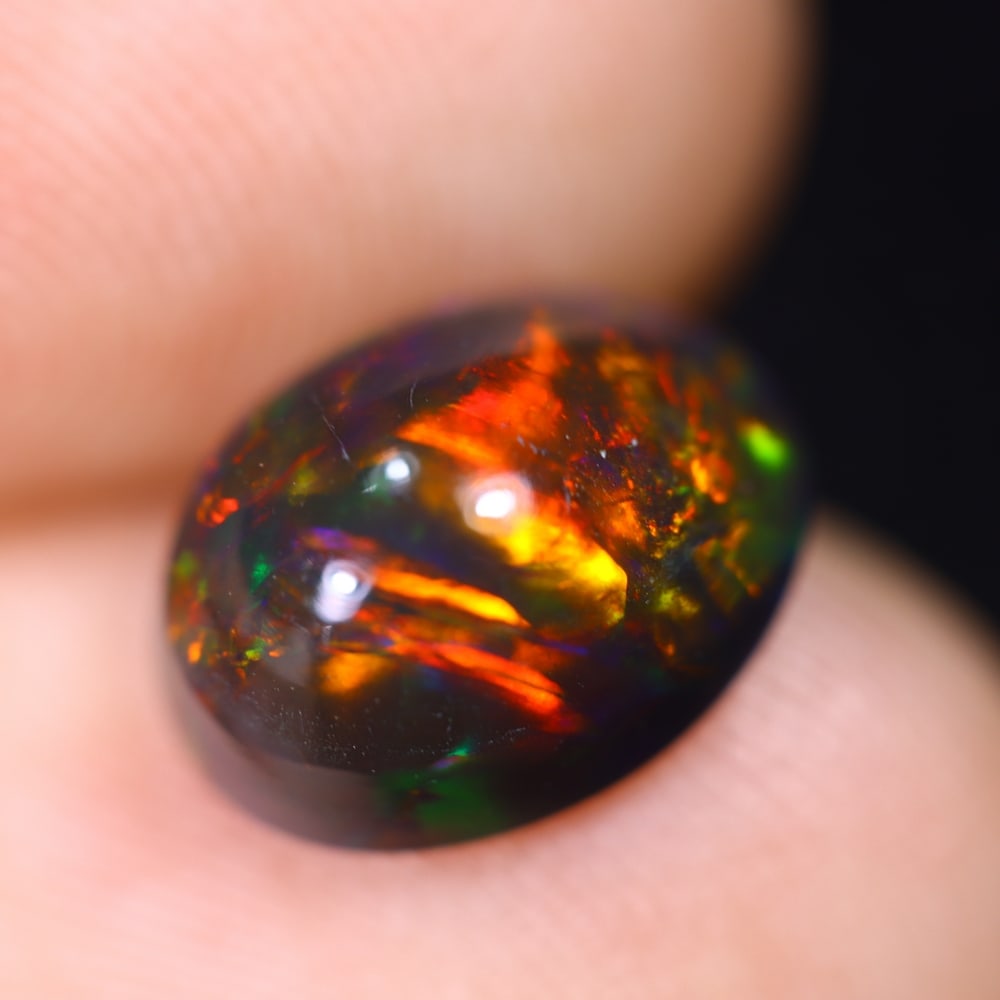 1.98Ct Welo Black Opal Polished - Ethiopian Opal , 57E: Ksmith Heritage Auctioneers Subject: Natural Ethiopian Welo Black Opal Origin: Ethiopia Carat Weight: 1.98Ct Dimension: 10.2x8x5.3 mm Treatment: Smoked Type: Cabochon, Pol