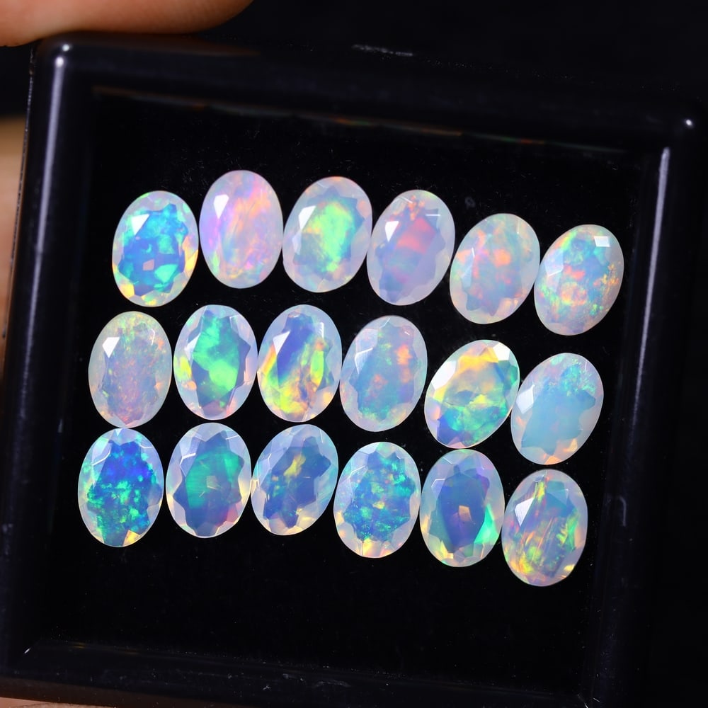 *7.97Ct 18pcs Calibrated 7x5mm Faceted Welo Opal Set - Ethiopian Opal, 300B: Ksmith Heritage Auctioneers Subject: Natural Ethiopian Welo Opal Origin: Ethiopia Carat Weight: 7.97Ct Treatment: Natural Untreated Type: Faceted, Polished