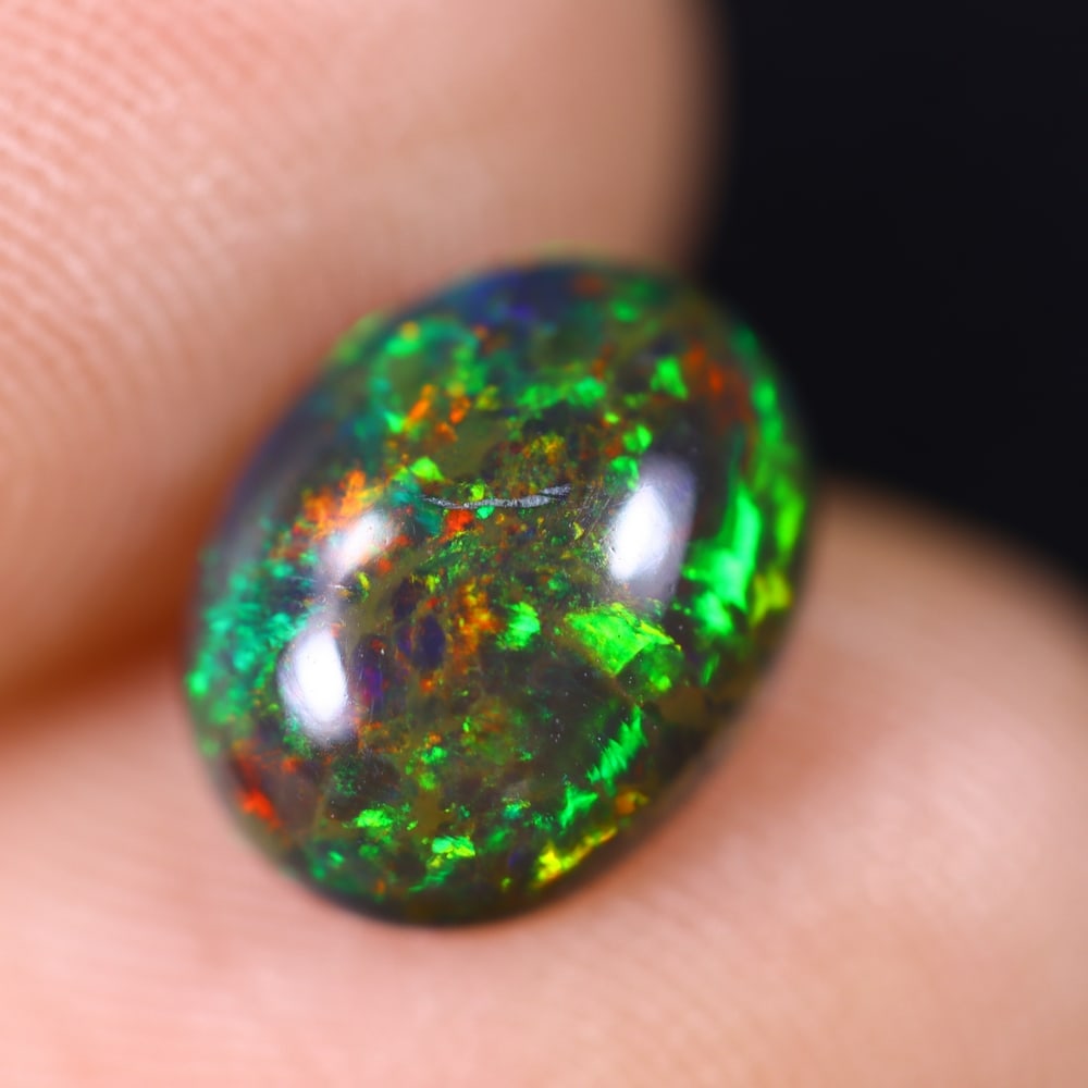 1.36Ct Welo Black Opal Polished - Ethiopian Opal , 202E: Ksmith Heritage Auctioneers Subject: Natural Ethiopian Welo Black Opal Origin: Ethiopia Carat Weight: 1.36Ct Dimension: 9.7x7.6x3.7 mm Treatment: Smoked Type: Cabochon, Po