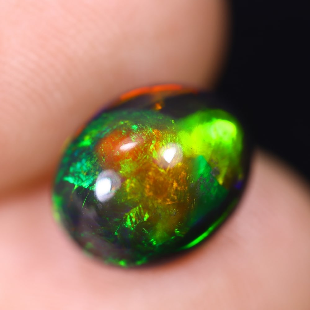2.10Ct Welo Black Opal Polished - Ethiopian Opal , 716E: Ksmith Heritage Auctioneers Subject: Natural Ethiopian Welo Black Opal Origin: Ethiopia Carat Weight: 2.10Ct Dimension: 10.1x8.2x5.3 mm Treatment: Smoked Type: Cabochon, P