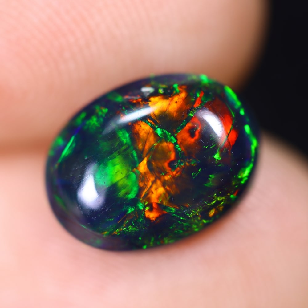 1.81Ct Welo Black Opal Polished - Ethiopian Opal , 288E: Ksmith Heritage Auctioneers Subject: Natural Ethiopian Welo Black Opal Origin: Ethiopia Carat Weight: 1.81Ct Dimension: 10.5x8.1x4.3 mm Treatment: Smoked Type: Cabochon, P