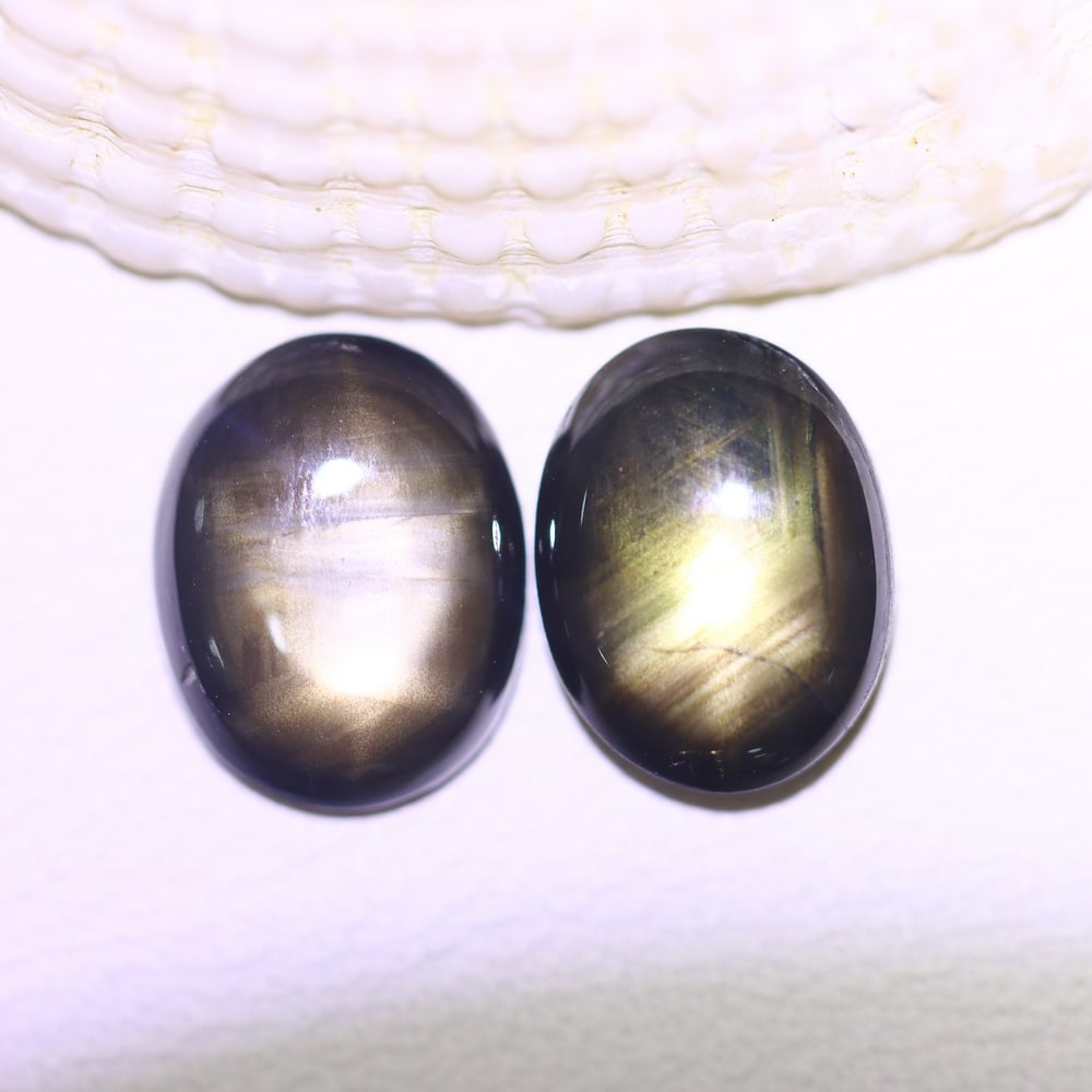 4.50cts 6 Rays Black Star Sapphire Pair , 468E: Ksmith Heritage Auctioneers Subject: Natural 6 Rays Star Sapphire Origin: Myanmar Carat Weight: 4.50cts Dimension: 8.7x6.7x3.2 mm Treatment: Diffusion Type: Cabochon, Poli
