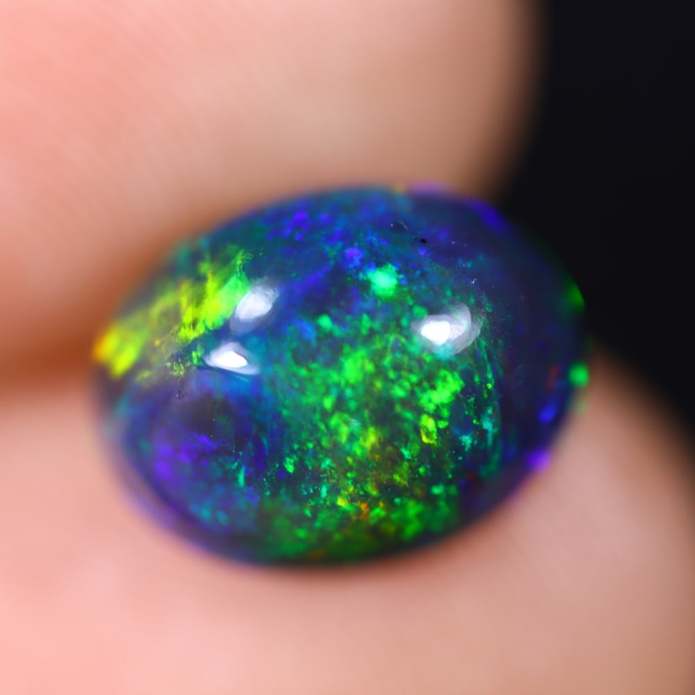 3.46Ct Welo Black Opal Polished - Ethiopian Opal , 455E: Ksmith Heritage Auctioneers Subject: Natural Ethiopian Welo Black Opal Origin: Ethiopia Carat Weight: 3.14Ct Dimension: 11x8.5x6.8 mm Treatment: Smoked Type: Cabochon, Pol