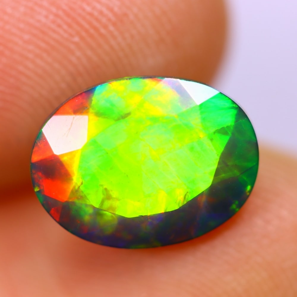 2.25Ct Welo Black Opal Polished - Ethiopian Opal - Oval Faceted , 187E: Ksmith Heritage Auctioneers Subject: Natural Ethiopian Welo Black Opal Origin: Ethiopia Carat Weight: 2.25Ct Dimension: 11.4 x 8.6 x 5.2 mm Treatment: Smoked Shape: Oval