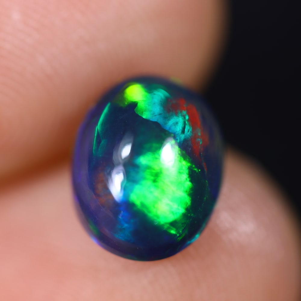 *1.49Ct Welo Black Opal Polished - Ethiopian Opal , 458E: Ksmith Heritage Auctioneers Subject: Natural Ethiopian Welo Black Opal Origin: Ethiopia Carat Weight: 1.49Ct Dimension: 9.6x7.6x4.6 mm Treatment: Smoked Type: Cabochon, Po