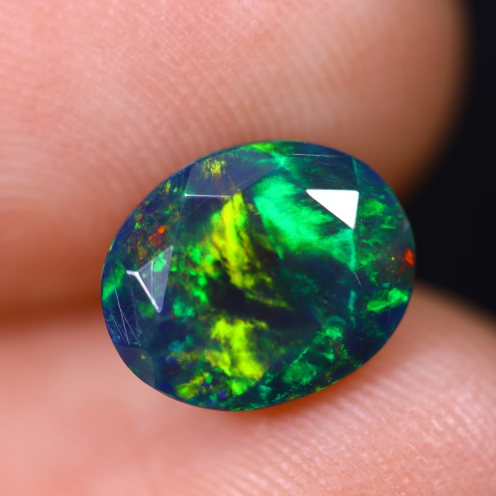 1.56Ct Welo Black Faceted Opal Polished - Ethiopian Opal , 260E: Ksmith Heritage Auctioneers Subject: Natural Ethiopian Welo Black Opal Origin: Ethiopia Carat Weight: 1.59Ct Dimension: 9.4x7.6x5.4 mm Treatment: Smoked Type: Faceted, Pol