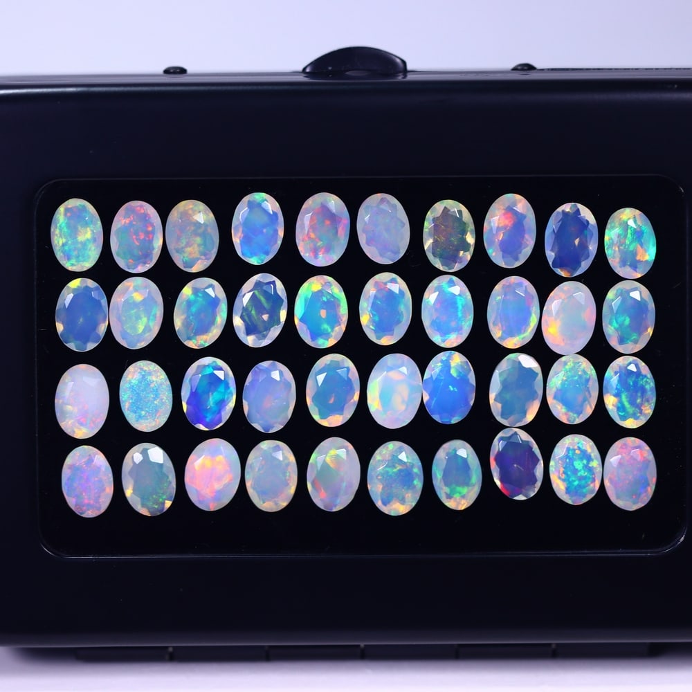 *20.63Ct Calibrated 7x5mm Faceted Welo Opal Set - Ethiopian Opal , 113E: Ksmith Heritage Auctioneers Subject: Natural Ethiopian Welo Opal Origin: Ethiopia Carat Weight: 20.63Ct Treatment: Natural Untreated Type: Faceted, Polished