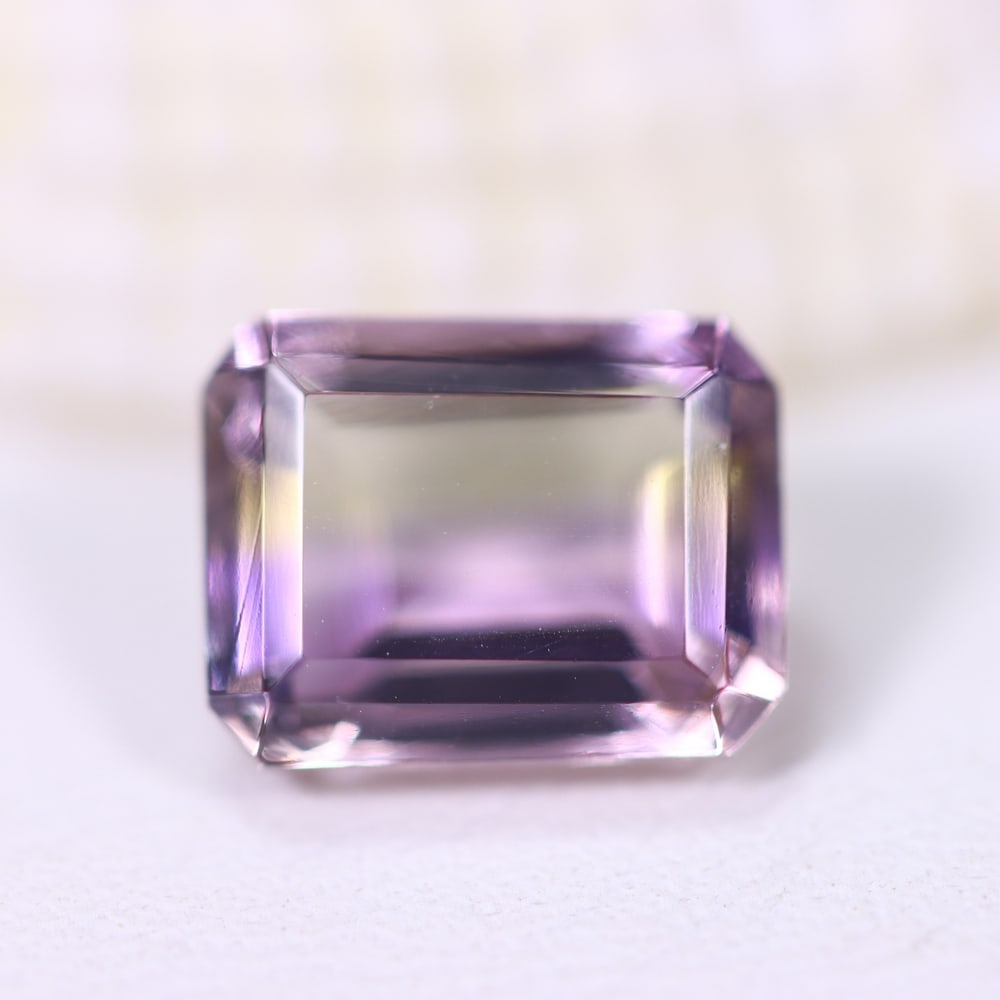 2.07Ct Ametrine - Polished Faceted - Rectangle Faceted , 600E: Ksmith Heritage Auctioneers Subject: Natural Ametrine Origin: Bolivia Carat Weight: 2.07Ct Dimension: 8.6x6.7x4.5 mm Treatment: Unheated Shape: Rectangle Type: F