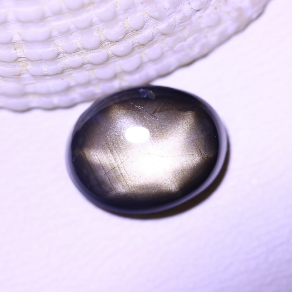 4.76cts 6 Rays Black Star Sapphire , 1104E: Ksmith Heritage Auctioneers Subject: Natural 6 Rays Star Sapphire Origin: Myanmar Carat Weight: 4.76cts Dimension: 10.8x8.5x4.3 mm Treatment: Diffusion Type: Cabochon, Pol