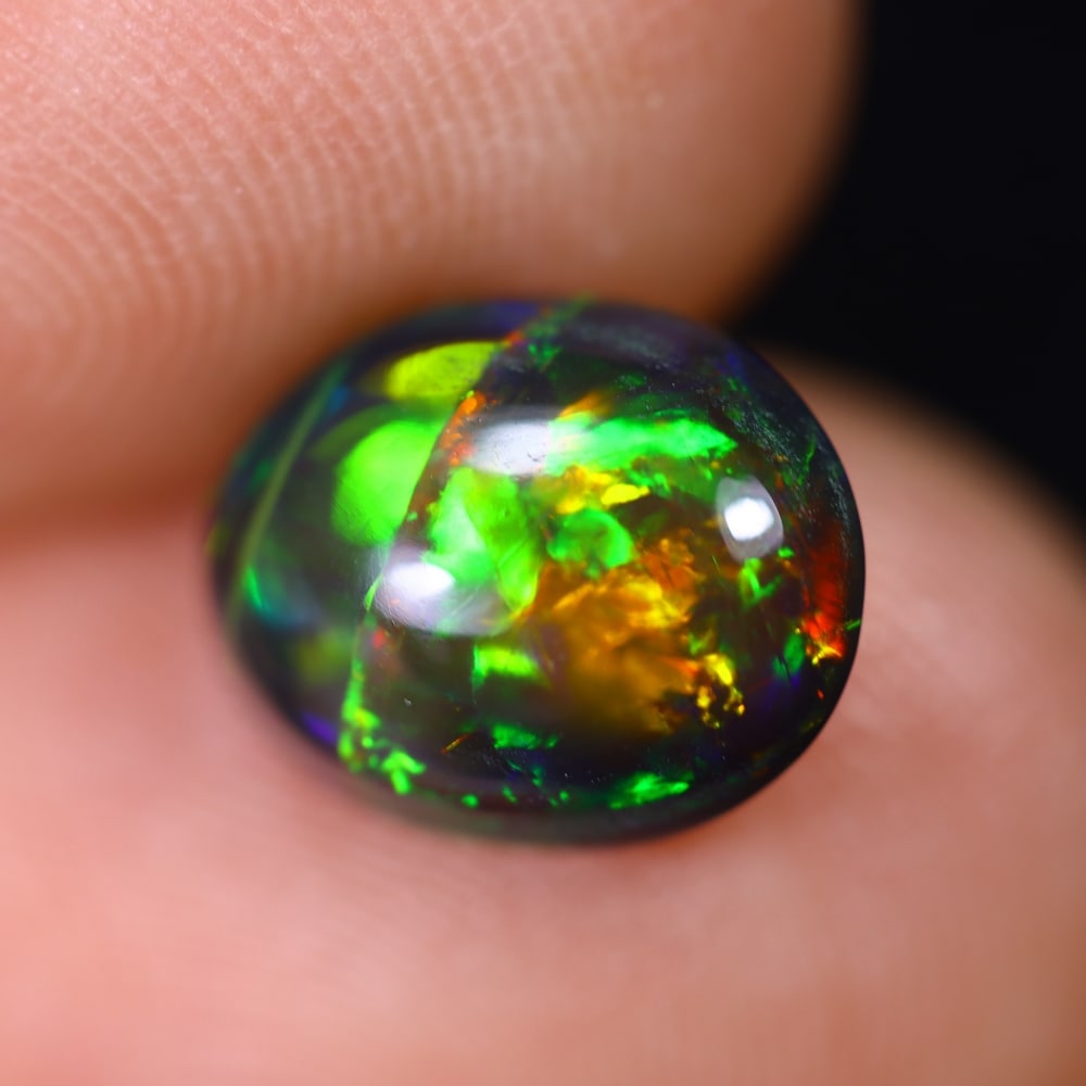 1.61Ct Welo Black Opal Polished - Ethiopian Opal , 588E: Ksmith Heritage Auctioneers Subject: Natural Ethiopian Welo Black Opal Origin: Ethiopia Carat Weight: 1.61Ct Dimension: 10x7.8x4.1 mm Treatment: Smoked Type: Cabochon, Pol