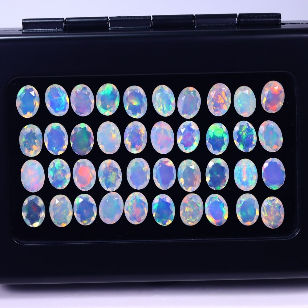 *19.44Ct Calibrated 7x5mm Faceted Welo Opal Set - Ethiopian Opal , 966E: Ksmith Heritage Auctioneers Subject: Natural Ethiopian Welo Opal Origin: Ethiopia Carat Weight: 19.44Ct Treatment: Natural Untreated Type: Faceted, Polished