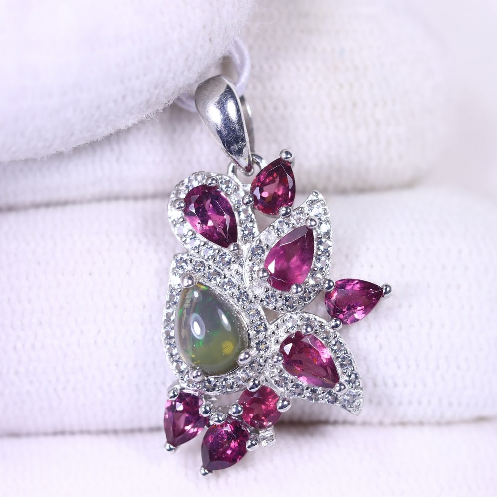 Pendant Black Opal Rhodolite Garnet & Zircon - 925 Sterling Silver , 58E: Ksmith Heritage Auctioneers Subject: Natural Black Opal, Rhodolite Garnet & Zircon Origin: Thailand Carat Weight: 13.06ct Dimension: Gemstone 5x7mm Type: Pendant