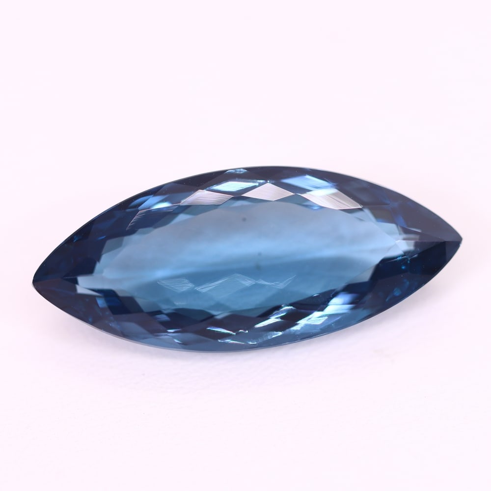 *25.74Ct London Blue Topaz - Polished Faceted , 211C: Ksmith Heritage Auctioneers Subject: Natural Blue Topaz Origin: Myanmar Carat Weight: 25.74Ct Dimension: 30.4x12.8x7.9 mm Treatment: Irridiated Type: Faceted, Polished