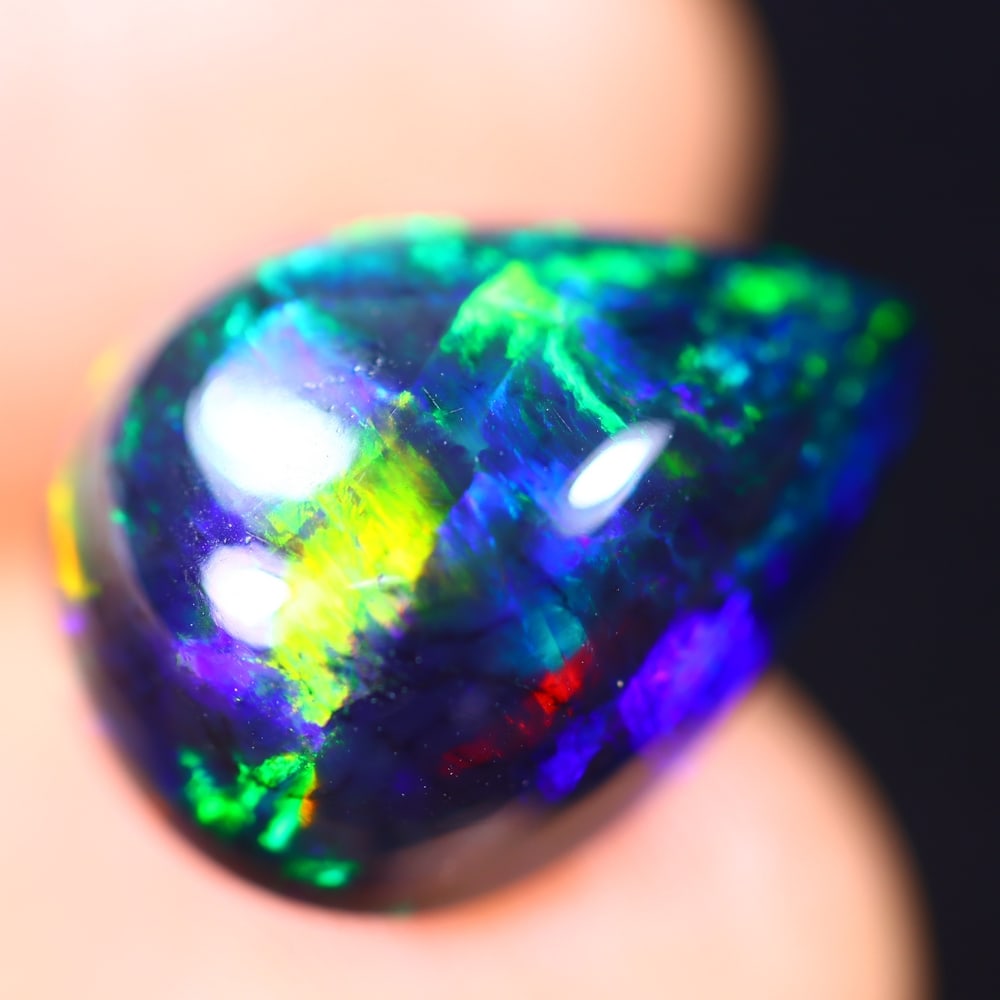 *6.81Ct Welo Black Opal Polished - Ethiopian Opal - Pear Cabochon , 45E: Ksmith Heritage Auctioneers Subject: Natural Ethiopian Welo Black Opal Origin: Ethiopia Carat Weight: 6.81Ct Dimension: 15.8 x 11.9 x 7.6 mm Treatment: Smoked Shape: Pear<
