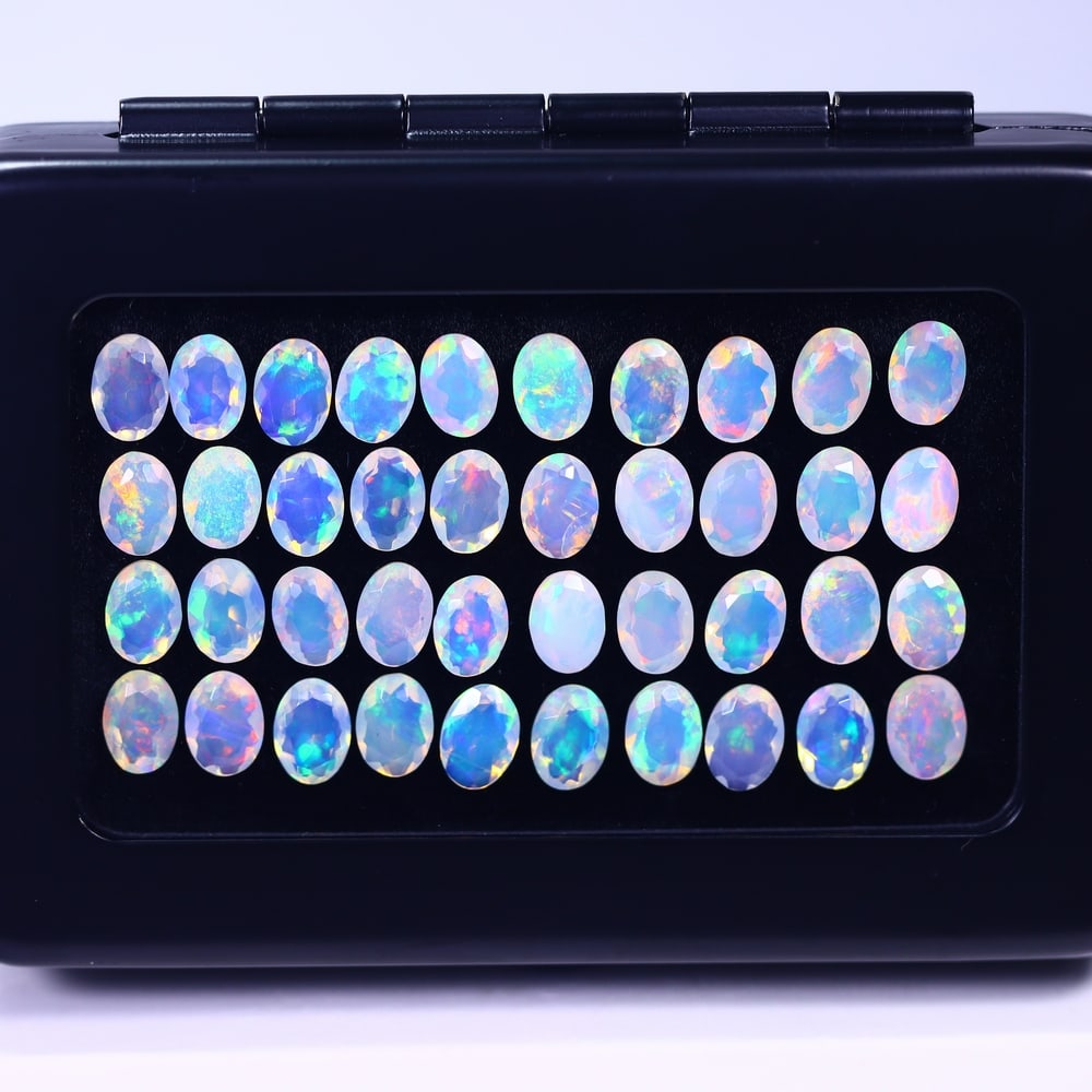 *19.48Ct Calibrated 7x5mm Faceted Welo Opal Set - Ethiopian Opal , 563E: Ksmith Heritage Auctioneers Subject: Natural Ethiopian Welo Opal Origin: Ethiopia Carat Weight: 19.48Ct Treatment: Natural Untreated Type: Faceted, Polished
