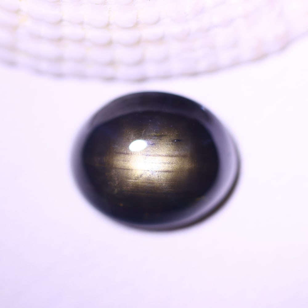 5.72cts 6 Rays Black Star Sapphire , 380E: Ksmith Heritage Auctioneers Subject: Natural 6 Rays Star Sapphire Origin: Myanmar Carat Weight: 5.72cts Dimension: 10.5x8.7x5.4 mm Treatment: Diffusion Type: Cabochon, Pol